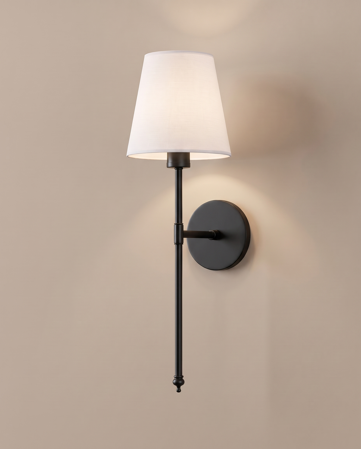 Wireless wall sconce glowing on a warm wall: Black