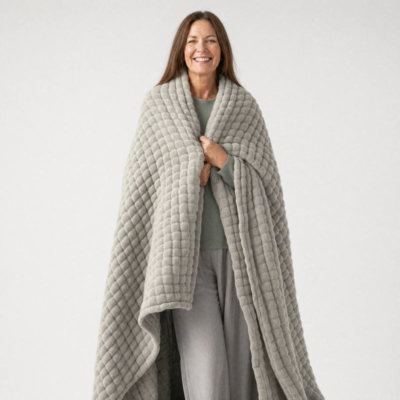 Woman wearing the Muslin Blanket in Grey draped over both shoulders