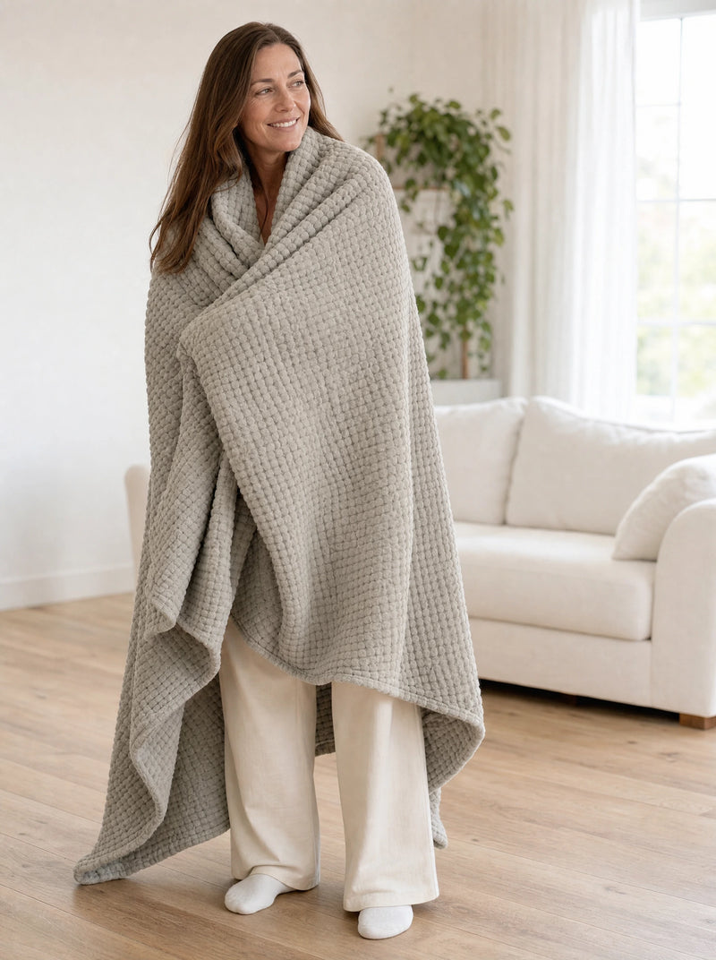 The Muslin Blanket in Dune draped over a bed
