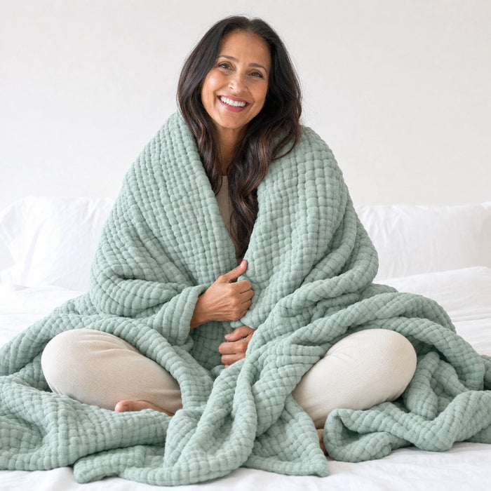 The Muslin Blanket folded on a bed