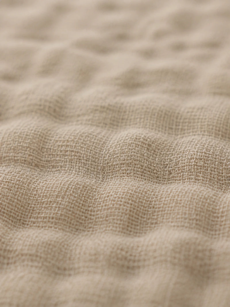 Macro photograph of the open crosshatch weave of 100% cotton muslin