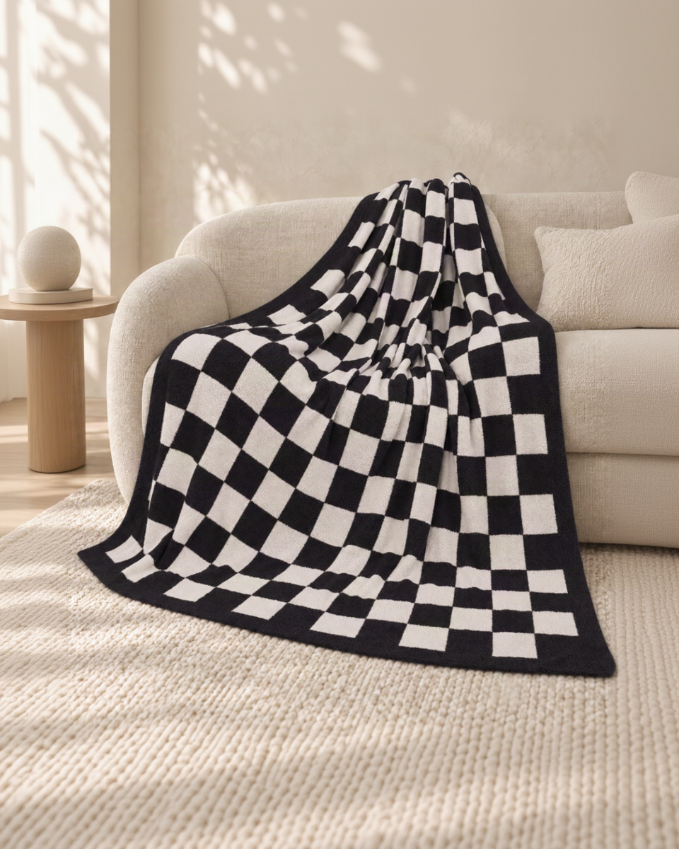 Black and ivory checkerboard throw on an oatmeal sofa