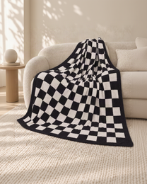 Black and ivory checkerboard throw on an oatmeal sofa