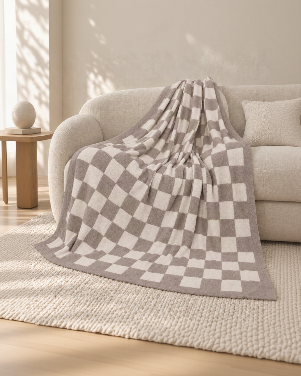 Gray and ivory checkerboard throw on an oatmeal sofa