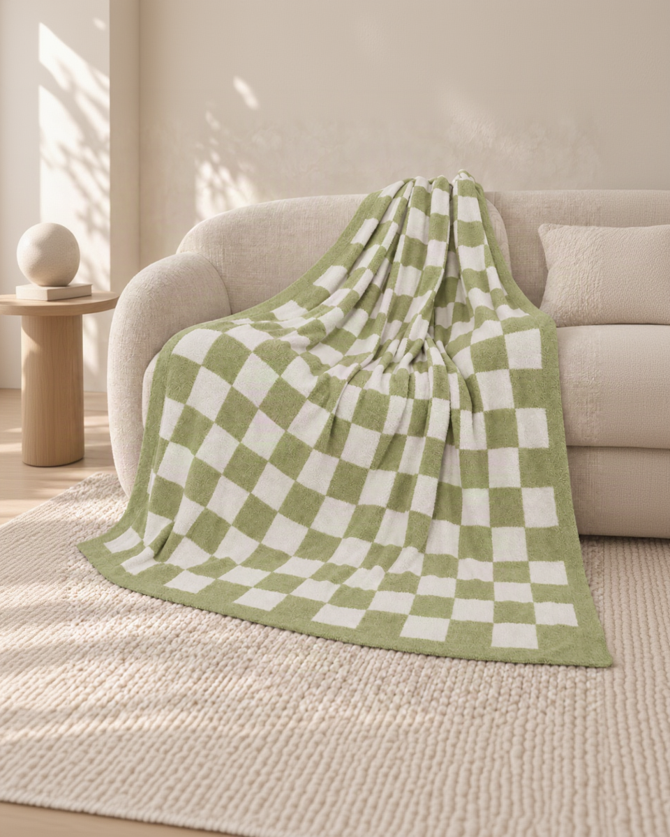 Green and ivory checkerboard throw on an oatmeal sofa