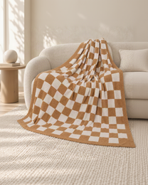 Sand and ivory checkerboard throw on an oatmeal sofa