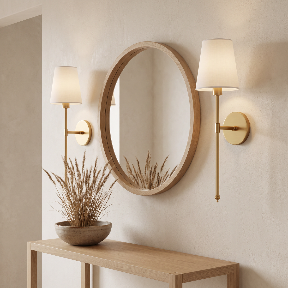 Gold wireless wall sconce beside a hallway mirror and console