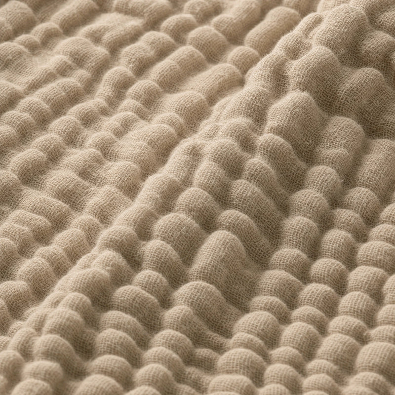 Macro of the Muslin Blanket in Dune showing the woven gauze puffs